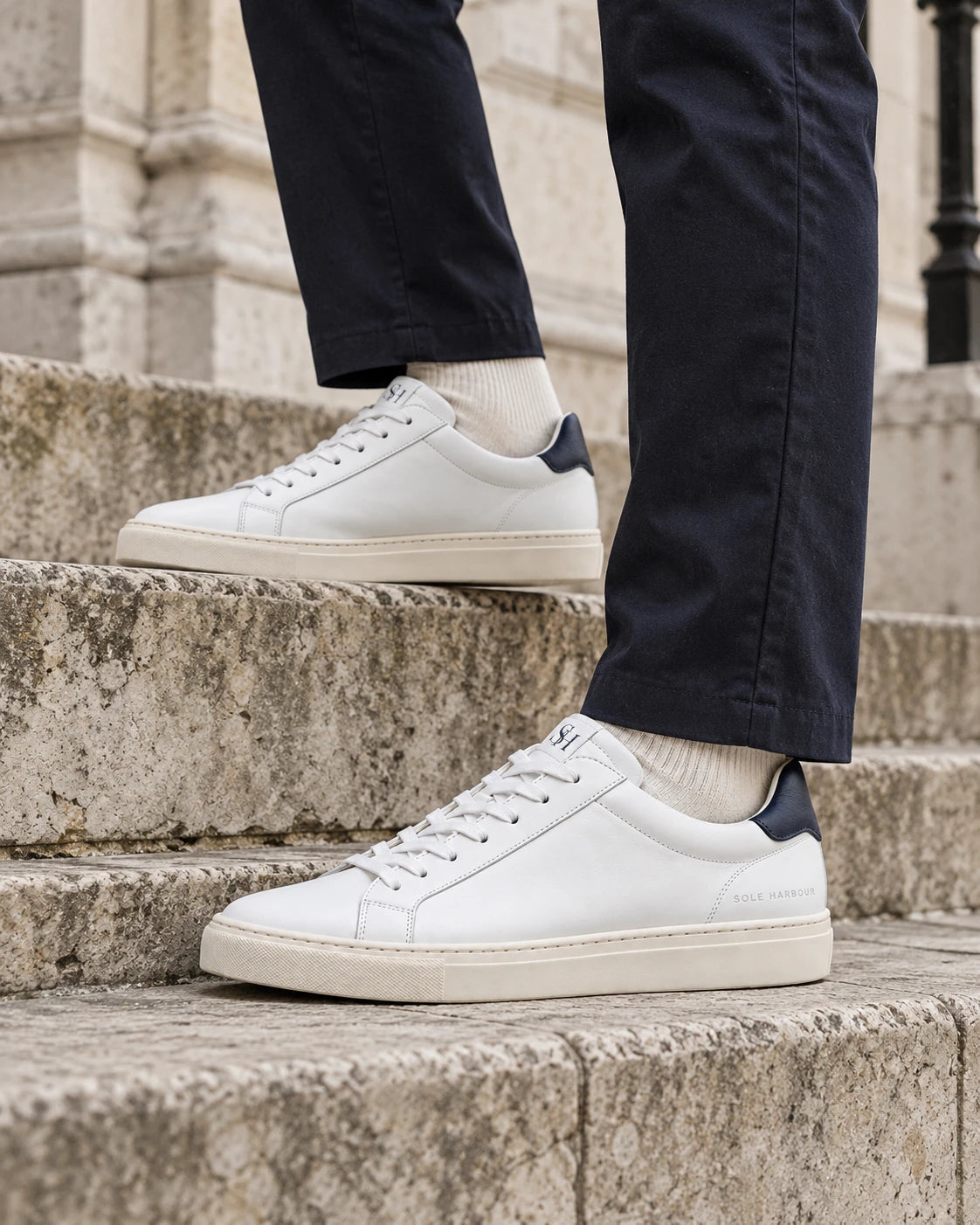 Sole Harbour Pier 01 sneakers worn with navy trousers on London stone steps